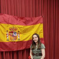 Melissa Dean posing in front of Spanish flag
